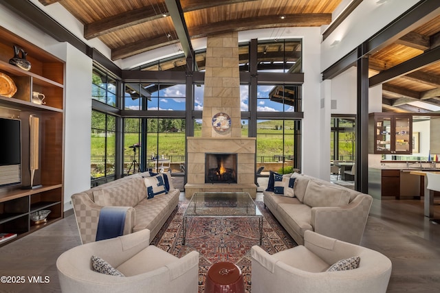 455 Old Creamery Rd, Edwards, CO 81632 - living area with a wooden ceiling with exposed beams, wood finished floors, high vaulted ceiling, healthy amount of natural light, and a tiled fireplace
