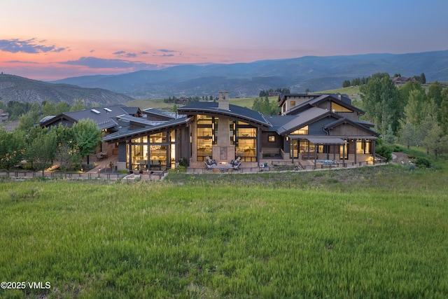455 Old Creamery Rd, Edwards, CO 81632 - back of property with a mountain view, a patio area, and a chimney