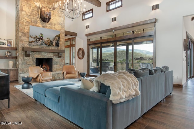 1288 E Haystacker Dr, Eagle, CO 81631 - living room with a towering ceiling, dark hardwood / wood-style floors, a notable chandelier, a mountain view, and a stone fireplace