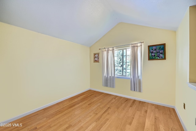 705 Crazy Horse Cir, Edwards, CO 81632 - empty room with light wood-type flooring, lofted ceiling, and baseboards
