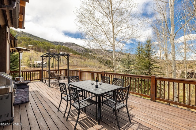 37 Aspen Meadows Rd, Edwards, CO 81632 - wooden terrace featuring outdoor dining area, a pergola, and a mountain view