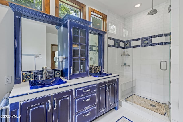225 Alcazar Dr, Edwards, CO 81632 - bathroom featuring a stall shower, double vanity, and tile patterned flooring