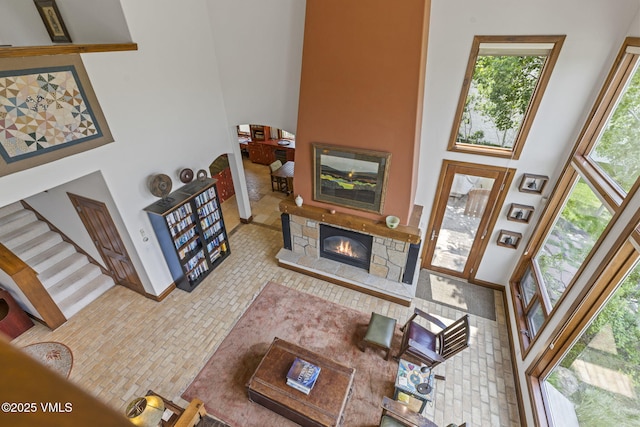 225 Alcazar Dr, Edwards, CO 81632 - living area with a high ceiling, a fireplace, and brick patterned floors