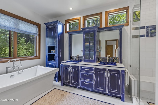225 Alcazar Dr, Edwards, CO 81632 - bathroom featuring plenty of natural light, a freestanding tub, double vanity, a shower stall, and recessed lighting