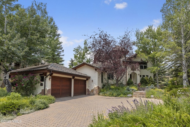 225 Alcazar Dr, Edwards, CO 81632 - view of front of house with an attached garage, driveway, stucco siding, and a tile roof