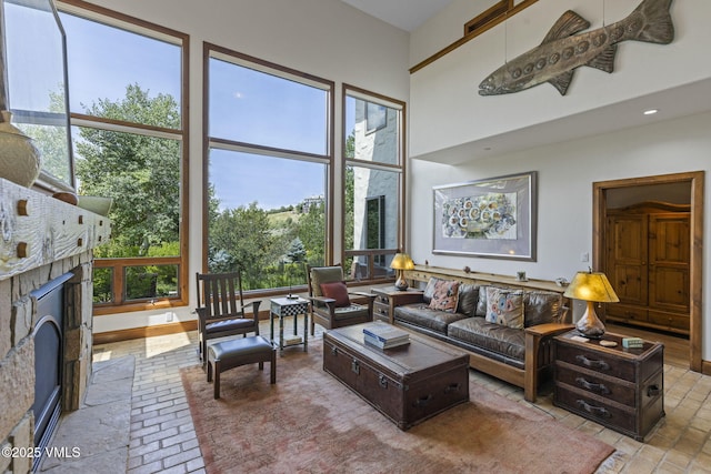 225 Alcazar Dr, Edwards, CO 81632 - living area with a brick fireplace, a towering ceiling, and brick flooring