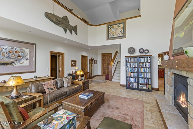 225 Alcazar Dr, Edwards, CO 81632 - living area with brick floors, stairway, a fireplace, and a high ceiling