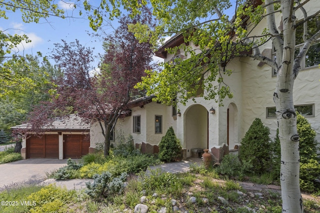225 Alcazar Dr, Edwards, CO 81632 - view of front of property with stucco siding, driveway, and an attached garage