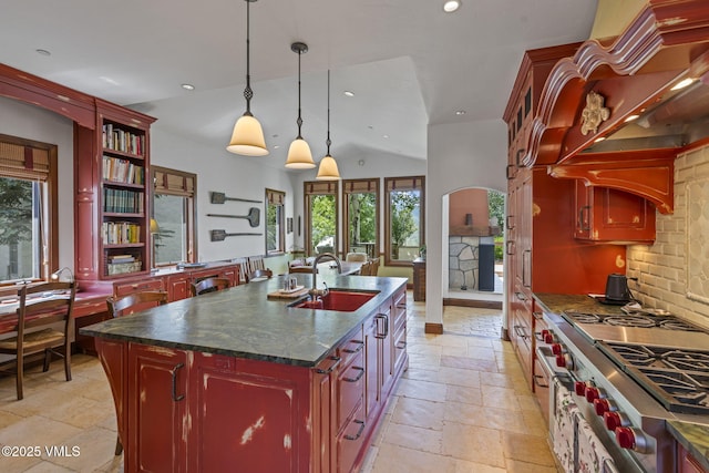 225 Alcazar Dr, Edwards, CO 81632 - kitchen with stone tile floors, healthy amount of natural light, tasteful backsplash, reddish brown cabinets, and recessed lighting