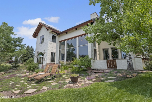 225 Alcazar Dr, Edwards, CO 81632 - back of property with stucco siding and a lawn