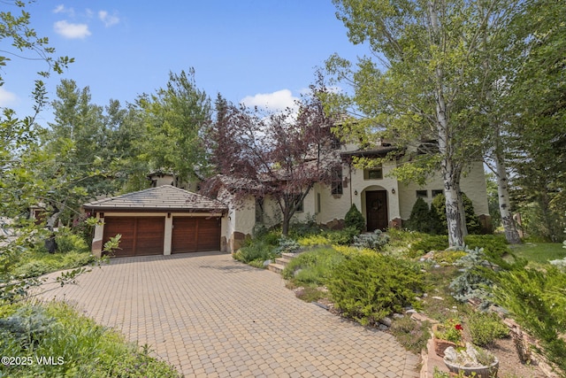 225 Alcazar Dr, Edwards, CO 81632 - view of front of home with stucco siding and decorative driveway