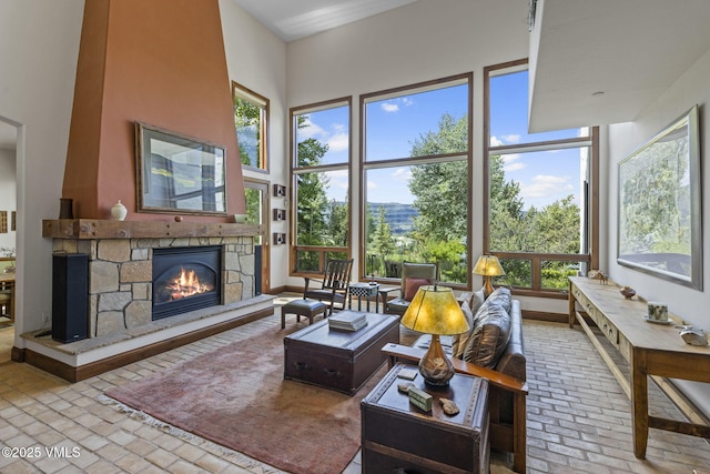 225 Alcazar Dr, Edwards, CO 81632 - living room featuring brick flooring, a fireplace, and healthy amount of natural light