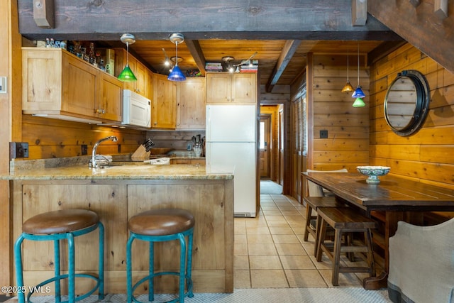 kitchen with white appliances, wooden ceiling, wood walls, a peninsula, and beam ceiling
