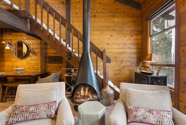 living area with a wood stove, wood walls, and vaulted ceiling