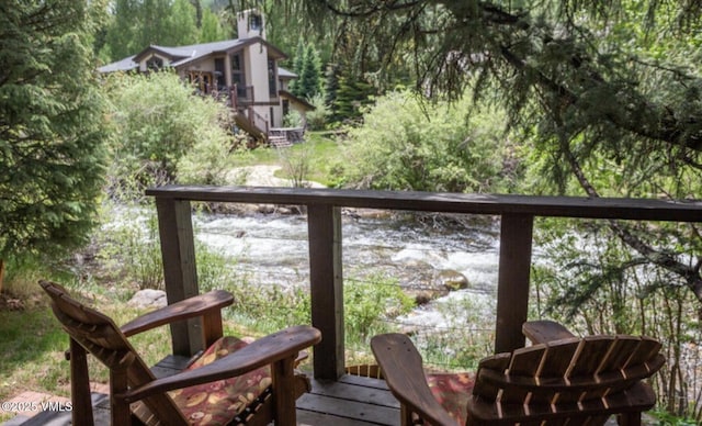 balcony with a view of trees and a water view
