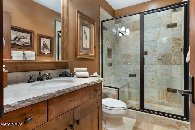 bathroom featuring vanity, toilet, and walk in shower