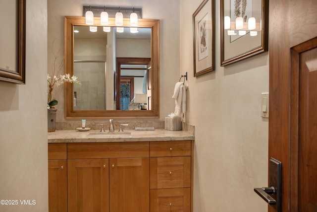 bathroom featuring vanity and an enclosed shower