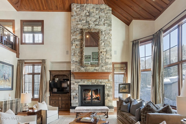 living room featuring a healthy amount of sunlight, a fireplace, and wooden ceiling