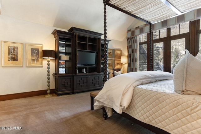 bedroom with vaulted ceiling and carpet flooring