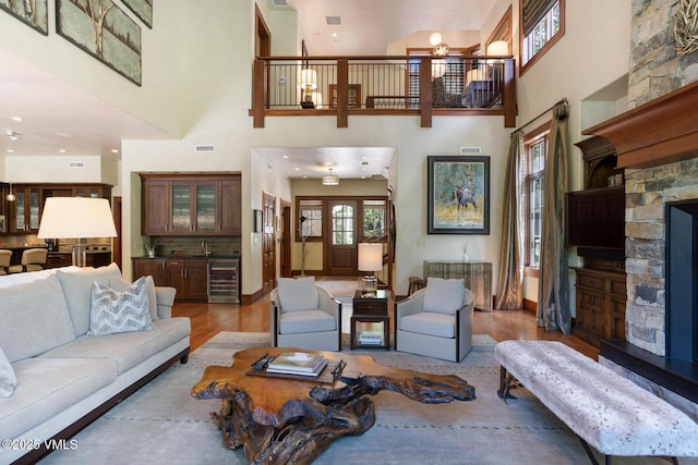 153 Village Walk, Beaver Creek, CO 81620 - living area with light wood-type flooring, a high ceiling, wine cooler, and healthy amount of natural light