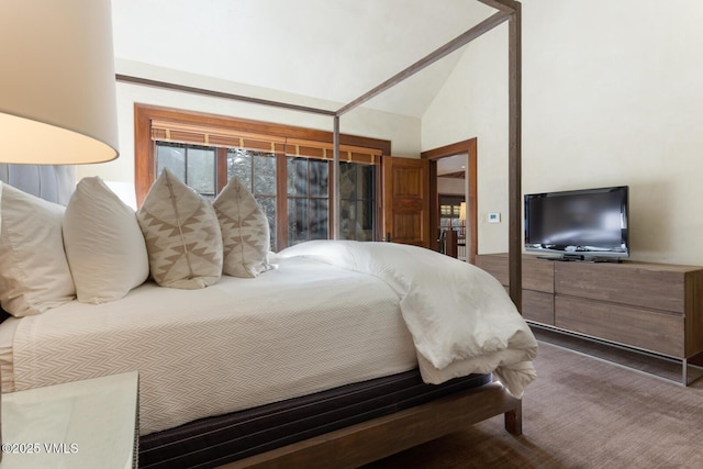 bedroom with high vaulted ceiling and carpet flooring