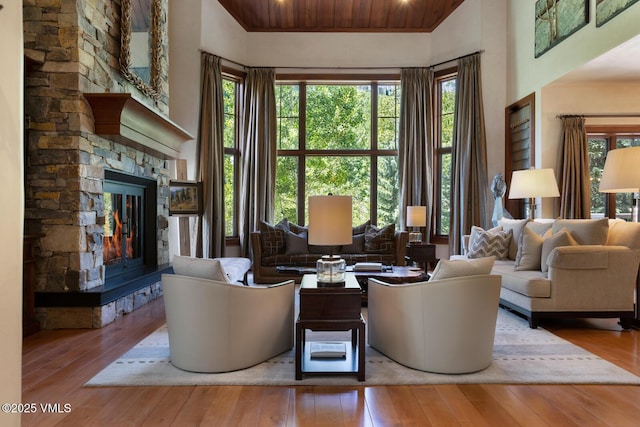 153 Village Walk, Beaver Creek, CO 81620 - living room with a fireplace, hardwood / wood-style flooring, a towering ceiling, and wooden ceiling