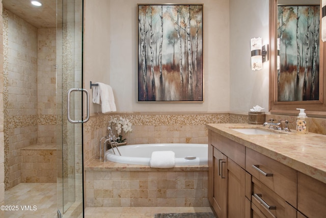 bathroom featuring vanity and shower with separate bathtub