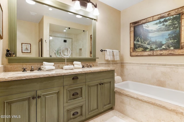 bathroom with vanity and a relaxing tiled tub