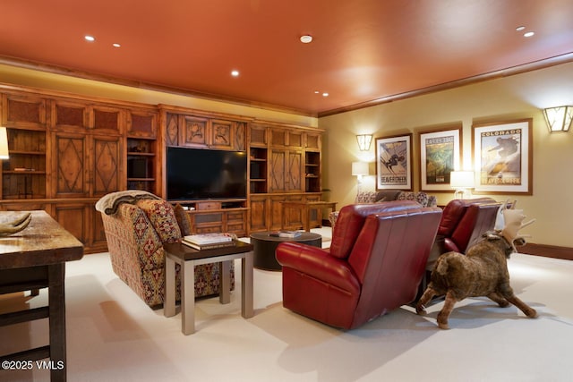 carpeted cinema room featuring ornamental molding