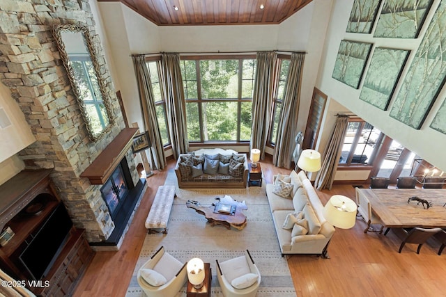 153 Village Walk, Beaver Creek, CO 81620 - living room featuring wood finished floors, a glass covered fireplace, wooden ceiling, healthy amount of natural light, and high vaulted ceiling