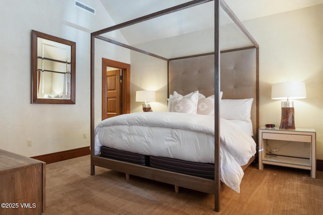 carpeted bedroom with lofted ceiling