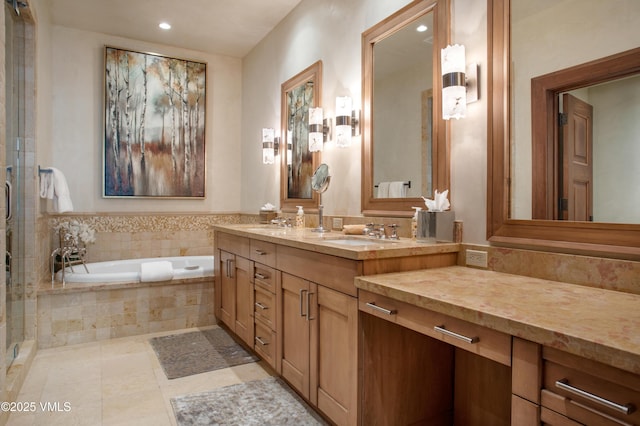 bathroom with vanity, tile patterned flooring, and a relaxing tiled tub