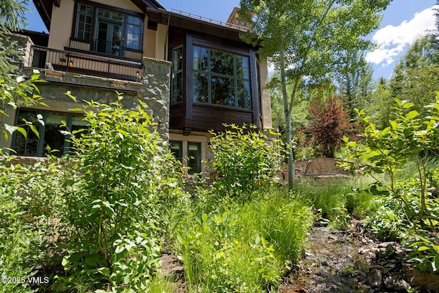 153 Village Walk, Beaver Creek, CO 81620 - rear view of house with a balcony and stucco siding
