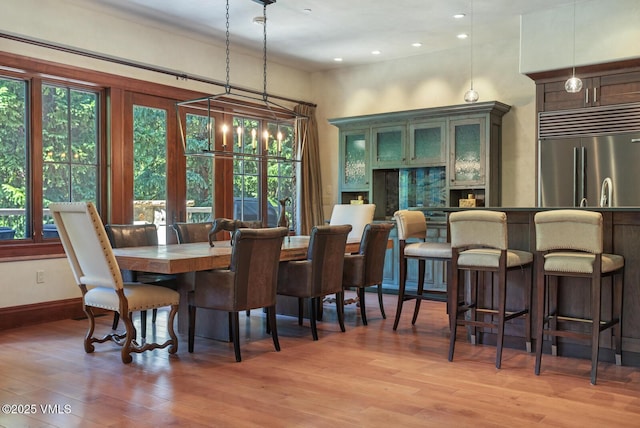 153 Village Walk, Beaver Creek, CO 81620 - dining room featuring light wood finished floors, recessed lighting, and bar