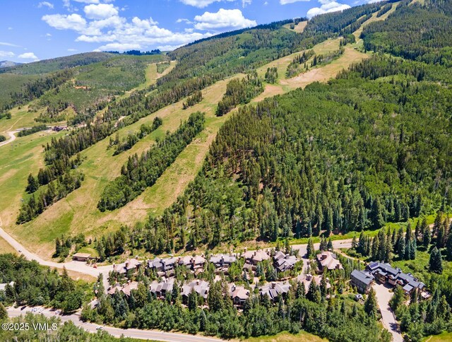153 Village Walk, Beaver Creek, CO 81620 - aerial view of property and surrounding area featuring a mountainous background and nearby suburban area