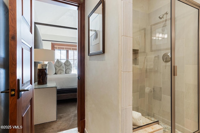 bathroom with wood-type flooring and a shower with shower door