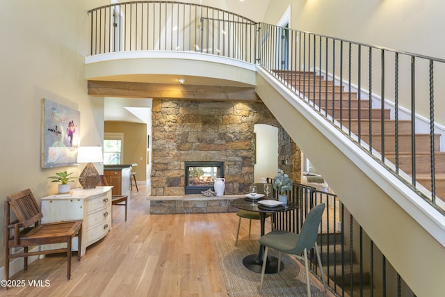 88 E Double Hitch, Eagle, CO 81631 - living area with hardwood / wood-style flooring, a towering ceiling, and a stone fireplace