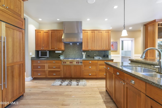 88 E Double Hitch, Eagle, CO 81631 - kitchen with wall chimney range hood, stainless steel gas cooktop, light wood finished floors, hanging light fixtures, and recessed lighting