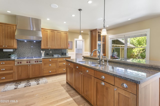 88 E Double Hitch, Eagle, CO 81631 - kitchen with wall chimney exhaust hood, stainless steel gas stovetop, brown cabinetry, light wood-style floors, and pendant lighting