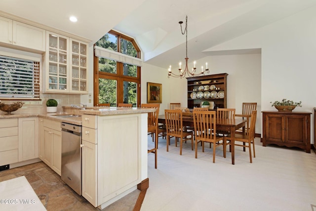 355 Offerson Rd Unit P4, Beaver Creek, CO 81620 - kitchen featuring dishwasher, a chandelier, vaulted ceiling, a peninsula, and glass insert cabinets