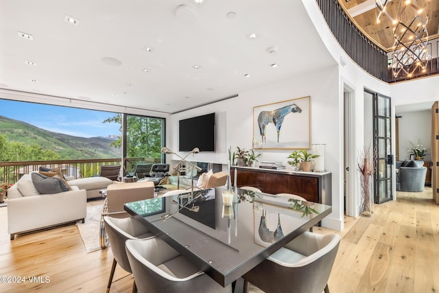 784 Potato Patch Dr Unit W, Vail, CO 81657 - dining room featuring light wood-style flooring, a chandelier, and floor to ceiling windows