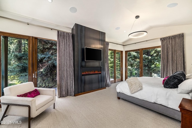 2764 S Frontage Rd, Vail, CO 81657 - carpeted bedroom with lofted ceiling, a fireplace, and multiple windows
