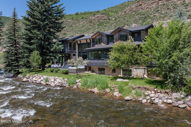 2764 S Frontage Rd, Vail, CO 81657 - back of property featuring a lawn, a water and mountain view, and a forest view