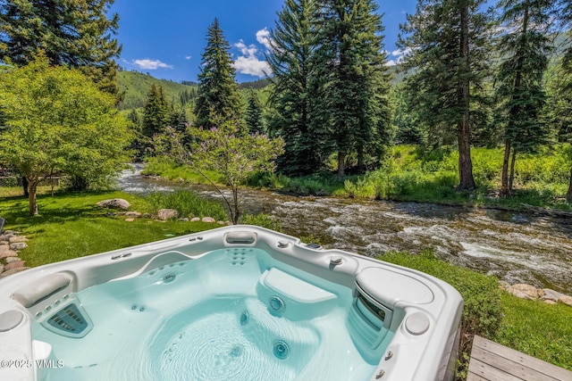 2764 S Frontage Rd, Vail, CO 81657 - view of pool with a hot tub and a view of trees