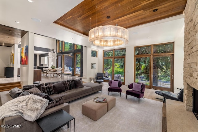 2764 S Frontage Rd, Vail, CO 81657 - living area featuring wood ceiling, a chandelier, a towering ceiling, a stone fireplace, and recessed lighting