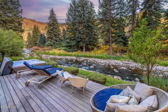2764 S Frontage Rd, Vail, CO 81657 - wooden deck with a forest view, an outdoor hangout area, and a covered hot tub