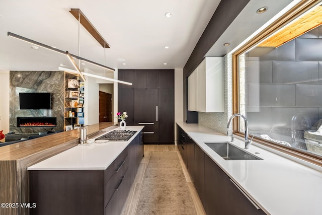 2764 S Frontage Rd, Vail, CO 81657 - kitchen with modern cabinets, dark brown cabinets, light countertops, stainless steel gas stovetop, and recessed lighting