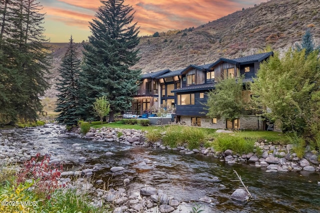 2764 S Frontage Rd, Vail, CO 81657 - back of house at dusk featuring a water and mountain view