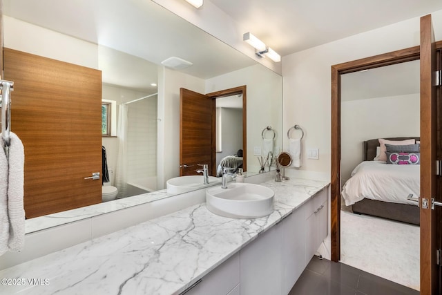 2764 S Frontage Rd, Vail, CO 81657 - ensuite bathroom with vanity, tub / shower combination, and tile patterned flooring