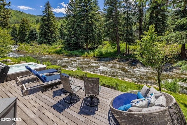 2764 S Frontage Rd, Vail, CO 81657 - deck with a hot tub and a view of trees